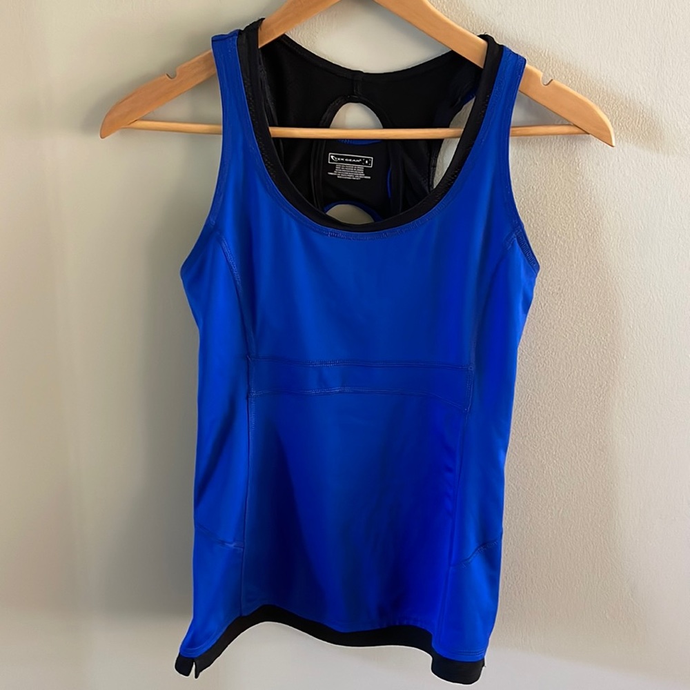 Like-new Tek Gear tank top in bright blue with black bra underneath.